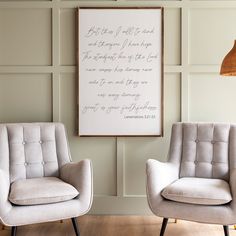 two chairs sitting next to each other in front of a framed poem