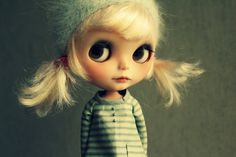 a doll with blonde hair and big eyes