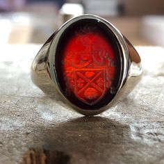 Made to order - 925 sterling silver or 10K - 14K - 18K Solid Gold, signet ring engraved with your university's logo, family crest or any image you request. There is no extra cost for side engravings. ✔Ring Details Ring stone 16mm Metal: 10K Gold, 14K, 18K Gold or 925 Sterling SILVER Please send us a sample image you would like engraved after placing an order. ✈️ Shipping Policy FREE EXPRESS SHIPPING to USA and EU. We use Fedex, TNT, UPS for express shipping. For shipping services, you will be provided with a tracking number. ➡️After the full payment is received, the product will be shipped within 5-7 business days. Fast shipping is delivered within approximately 1-4 business days. 📯 Import duties, taxes and charges are not included in the item price or shipping charges. Customs or charges Heirloom Red Signet Ring With Polished Finish, Classic Carnelian Signet Ring For Anniversary, Classic Carnelian Signet Ring For Formal Events, Classic Carnelian Signet Ring For Formal Occasions, Classic Carnelian Signet Ring With Polished Finish, Heirloom Signet Ring With Cabochon As A Gift, Heirloom Signet Ring With Cabochon For Gift, Formal Red Engraved Ring With Polished Finish, Silver Signet Ring With Intaglio As Gift