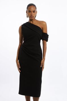 a woman is wearing a black dress with one shoulder