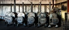 several large metal containers are lined up against the wall