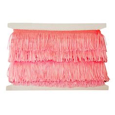 a piece of pink fabric with fringes on it