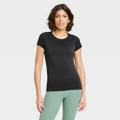 Women's Seamless Short Sleeve Shirt - All In Motion™ Solid Compressive Athleisure T-shirt, Functional Black Tops With Seamless Design, Functional Black Top With Seamless Design, Functional Black Seamless Tops, High Stretch Moisture-wicking T-shirt, Black Snug Fit T-shirt For Athleisure, Black Snug Fit T-shirt Athleisure, Casual Moisture-wicking Snug Fit T-shirt, Go-dry Athleisure T-shirt