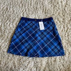 New With Tags Lady Hagen Skirt With Built In Shorts. Shorts Inside Are A Stretchy Material And Navy Blue. Outside Skirt Is Slightly Stretchy Material, Royal Blue, Gold, Navy, White Plaid. Waist Band Is Not Stretchy, Has A Few Folding Marks From The Hanger Due To The Type Of Material. Zipper And Button Closure, Pockets On Front. Gusset And Pockets On Back. Hydrodri Fabric. Women’s Size 6. Preppy High Waist Lined Skirt, Preppy School Skirt Bottoms, Stretch Lined Skirt Bottoms For School, Blue Fitted Preppy Shorts, Stretch Lined Skirt For School, Fitted Preppy Blue Shorts, Preppy Fitted Blue Shorts, Preppy Relaxed Fit Skirt, School Lined Skirt Bottoms