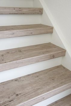 wooden steps leading up to a white wall