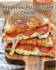 a grilled cheese and pepperoni pizza sandwich on a cutting board