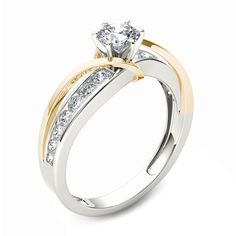 a white and yellow gold engagement ring with diamonds on the side, set in two tone gold