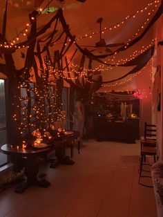 a room filled with lots of lights next to a table and chairs in front of a window