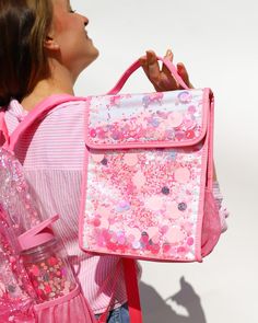 Make school or work a party with our best-selling confetti backpack and lunch box! Featuring our signature pink confetti, this backpack and lunch box set is sure to brighten your day while keeping your essential items secure. Pink Party Large Backpack Dimensions: 14"W x 6.5"D x 18"H Clear vinyl backpack with pink confetti Front pocket & 2 exterior water bottle pockets Pink nylon adjustable straps & top handle Luxe gold finishes & hardware Pink Party Confetti Insulated Lunch Box Dimensions: 10.5" Pack A Lunch, Disco Theme Party, Clear Backpacks, Insulated Backpack, Glitter Backpack, Clear Stadium Bag, Baby Bubble Romper, Stadium Bag, Party Confetti