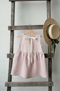 Smock dress is made of 100% soft medium weight linen.  Details: - Choose size and embroidery in the drop down menu - Colour: Baby pink - Composition: 100% Oeko-Tex certified linen - Sleeveless  - Gathered waist  - White ribbon in the back - Medium weight linen - Linen care: machine wash gentle; tumble dry low, ironing optional - The price is for one smock dress, other pictured items are not included Sleeveless Linen Dress, Girls Dresses Summer, Smock Dress, Linen Dresses, Linen Dress, Kids' Dresses, Baby Pink, Kids Dress, Baby Dress