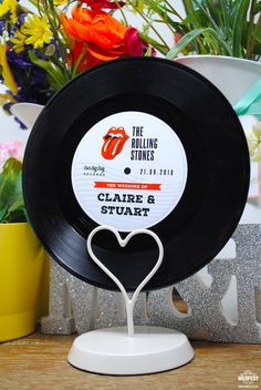 the rolling stones'cake and start logo is displayed on a plate with flowers in the background