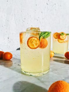 two glasses filled with lemonade and orange slices