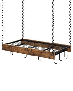 a wooden bed frame with metal hooks hanging from it's sides and two chains on each side