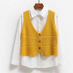 a white shirt and yellow vest on a hanger