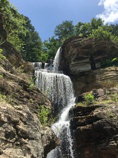 a large waterfall in the middle of some rocks