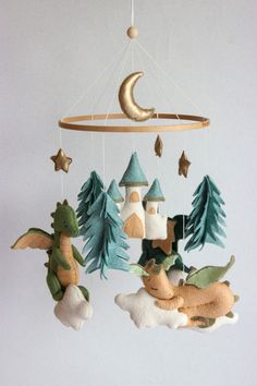 a mobile made to look like a castle with trees and stars hanging from the ceiling