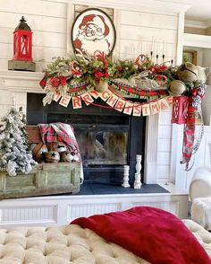 a living room decorated for christmas with stockings and garlands on the fireplace mantel