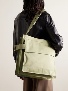 Inspired by its iconic trench coats, Burberry's tote bag is made from durable gabardine and has a wide, cinching strap with a polished gold-tone buckle shaped like a 'B'. The substantial size means it'll work well for an overnight trip. Burberry Mens Bag, Green Designer Shoulder Bag, Men’s Bags, Tote Bag Men, Festival Tote Bag, Mens Work Bags, Mens Designer Backpacks, Tote Bag For Men, Mens Tote Bag