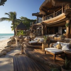 an outdoor lounge area on the beach next to the ocean