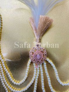 Elevate your wedding look with our stunning Wedding Kalgi with Pearl string for Groom. Handcrafted with precision, this Kalgi boasts of American Diamond jewelry, beautiful feathers, and pearls.  The Kalgi comes attached with 3 man-made pearl strands on either side to give your turban a regal touch. Safety Pin/Push Pin Attached It is completely handmade and beautifully crafted and stitched Premium Rich Men Kalangi Care Instruction: Don't use perfumes and deodorants directly on the product Traditional Pink Pearl Necklace For Wedding, Festive Pink Pearl Necklace For Wedding, Kalgi For Groom, Indian Wedding Accessories, Groom Turban, Beautiful Feathers, 3 Man, American Diamond Jewellery, Pin Pin