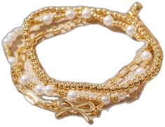 three bracelets with pearls and a gold bow