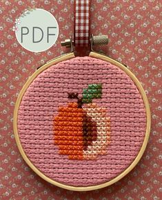 a cross - stitch pattern with an orange on it and the words kit written below