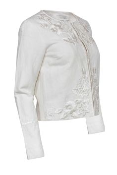 Grab this soft white jacket today for some light and airy style any season! Made with a floral embroidery, this Intermix piece will keep you warm over your favorite flowing maxi dress and strappy sandals. Size P 54% Cotton, 46% Linen Front hook closures Rounded neckline Embroidery throughout Waist 36” Sleeve 24” Shoulder to hem 20” Elegant Floral Embroidered Outerwear For Spring, Chic White Outerwear With Floral Embroidery, Elegant Summer Wedding Outerwear, Elegant Embroidered Spring Outerwear, Chic Floral Embroidered Outerwear For Spring, Spring Chic Outerwear With Floral Embroidery, Fitted Spring Outerwear With Intricate Embroidery, Spring Fitted Outerwear With Intricate Embroidery, Elegant White Embroidered Outerwear