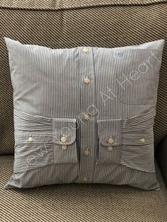 a gray and white striped pillow sitting on top of a couch