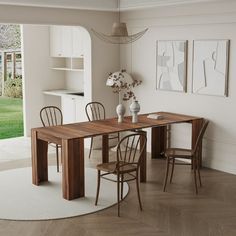 a dining room table and chairs in front of a sliding glass door