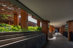 the walkway is lined with plants and wooden structures