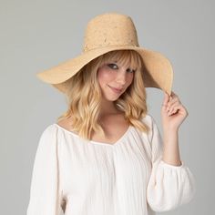 Our Glitz Wide Brim Fedora Sun Hat is a luxurious accessory for your summertime wardrobe. The delicate braid raffia is carefully crafted with attention to detail, and embedded with rhinestones to add a touch of sparkle. The 6" brim offers UPF 50+ sun protection and is adjustable for a perfect fit. Boasting a classic natural color and crafted from 100% premium raffia, this floppy fedora is a must-have for any fashionable collection. Features: Color: NaturalMaterials: 100% RaffiaBrim Size: 6" Brim Elegant Adjustable Braided Hat, Luxury Short Brim Straw Hat For The Beach, Luxury Short Brim Straw Hat For Beach, Luxury Straw Hat With Short Brim For Beach, Luxury Fedora Straw Hat For The Beach, Luxury Fedora Straw Hat For Beach, Luxury Summer Sun Hat, Luxury Curved Brim Sun Hat For Beach, Luxury Curved Brim Hat For The Beach