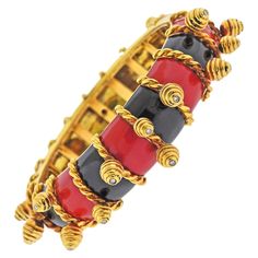 18k gold bangle bracelet with charms, each set with a diamond in the center. Bracelet decorated with black and red enamel. Will fit approx. 7.5" wrist and is 21mm wide. Marked 750, MFC. Weight - 145.1 grams. 18k Gold Bangle, Bracelet With Charms, Bangle Bracelets With Charms, Diamond Charm, Gold Bangle Bracelet, Gold Bangle, Charm Bangle, Antique Diamond, Gold Enamel