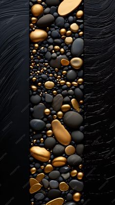 a black and gold wallpaper with lots of rocks on it's side,