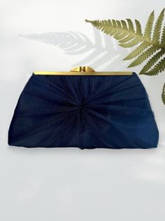 "A navy tulle and satin wedding clutch that can be personalized with a photo lining and inscription is the perfect accessory for any bride looking to add an extra special touch to her big day. The luxurious fabrics of tulle and satin bring an element of glamour and sophistication to any bridal ensemble, while the personalization element ensures that the clutch is unique and personal to the bride. The photo chosen to personalize the clutch can be a snapshot of a cherished moment or person in the Elegant Evening Bag With Satin Lining For Wedding, Elegant Navy Evening Bags, Elegant Navy Evening Bag, Wedding Evening Bag With Satin Lining, Blue Wedding Clutch Evening Bag, Elegant Blue Evening Bag For Wedding Guest, Blue Clutch Evening Bag For Wedding, Bridal Clutches, Bridesmaid Clutches