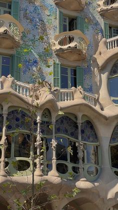 an unusual building with many windows and balconies