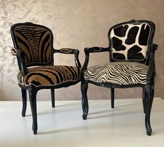 two zebra print chairs sitting next to each other