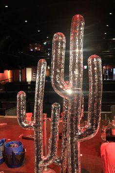 a giant cactus made out of soda bottles in the middle of a room filled with furniture