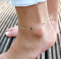 "This minimalist ultra thin anklet is perfect for bridesmaid or as wedding jewels. It's one minimalist ultra thin anklet made with sterling silver snake chain adorned with black miyuki beads. (you can choose your beads color and select it in the drop down menu) ➵ Perfect to wear alone or for layering with more bracelets. ➵ More Anklets : https://www.etsy.com/fr/shop/silverbirdjewels?ref=seller-platform-mcnav&section_id=21837916 --*--*--*--*--*--*--*--*--*--*--*--*--*--*--*--*--*--*-- ∞ SIZE ∞ - Length: Adjustable bracelet - around 20 cm (7,9 in) - 25 cm (9,8 in). If you like another length please make a note when you \"check out\" (I can make it for children) . ∞ MATERIAL ∞ - Sterling silver: All the silverbird jewels are made with 925 Sterling silver who is an alloy of silver, which consi Black Silver Anklets, Silver Black Beads Anklets, Silver Anklet With Black Beads, Ankle Beads, Anklet Design