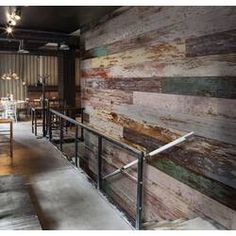 a restaurant with wooden walls and metal railings