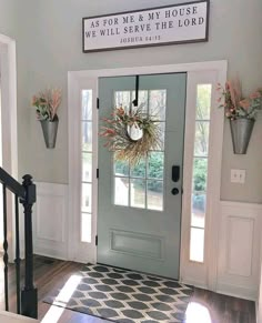 the front door is decorated with wreaths and flowers