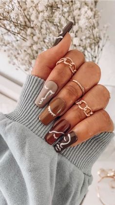 a woman's hand with four rings on her fingers and one ring on her finger