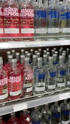 bottles of absolut vodka on display in a store