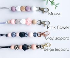 four different types of beaded keychains on a white background with text that says mauve, pink flower, gray leopard, and beige leopard