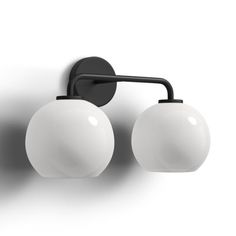 two white balls mounted on a black wall light with one ball attached to the arm