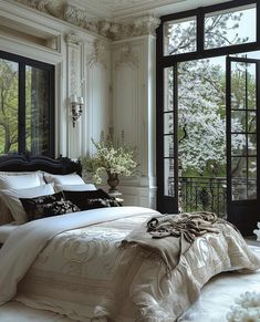 a large bed sitting in a bedroom next to a window filled with lots of windows