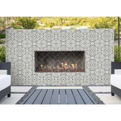 an outdoor fireplace is shown with white furniture and blue tiles on the wall behind it