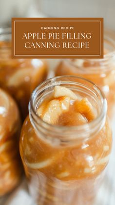 jars filled with apple pie filling sitting on top of a table