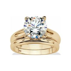 a gold engagement ring set with a round cut diamond in the center and two matching bands