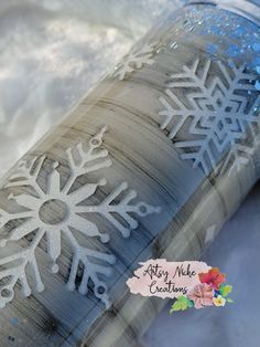 a tube with snow flakes on it sitting in the snow