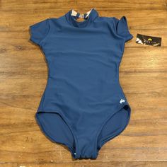 Maria Crown Smocked Neck Leotard Size Small Blue High Stretch Bodysuit For Swimming, High Stretch Blue Bodysuit For Swimming, Stretch Blue Bodysuit For Swimming, Casual Solid High Stretch Leotard, One-piece Stretch Tops For Swimming, Fitted Blue One-piece Leotard, Fitted Solid Nylon Leotard, Blue Stretch Leotard For Swimming, Blue Stretch Nylon Tops